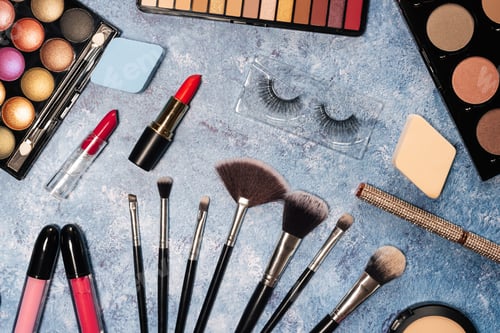 Preview: decorative cosmetics, makeup brushes false eyelashes on a blue background. the view from the top