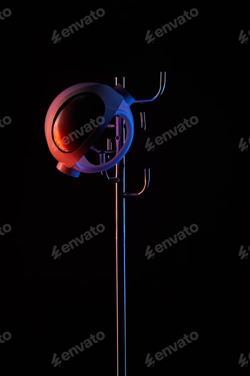 Preview: astronaut helmet on coat rack under toned light isolated on black