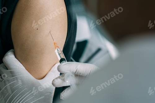 Preview: close up men doctor holding syringe and using cotton before make injection to men patient.