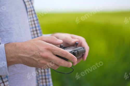 Preview: Smart farming concept, farmer using drone in field