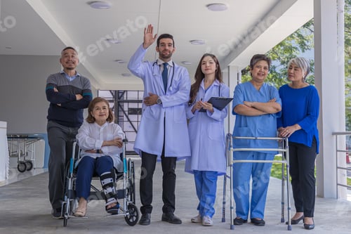 Preview: Doctors and nurse in hospital corridor with senior female and senior male patient in walker