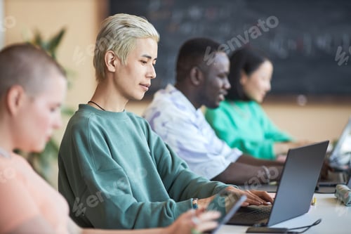 Preview: Focus on young Asian male student or programmer using laptop