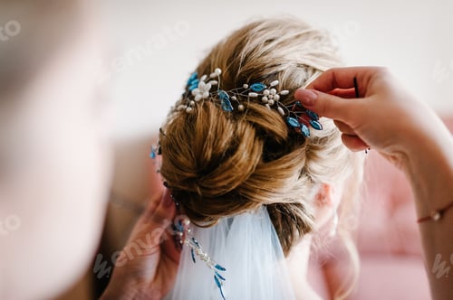 Preview: Mother hands holding ornaments and helping dressing veil bride. Bridesmaid preparing bride, helping