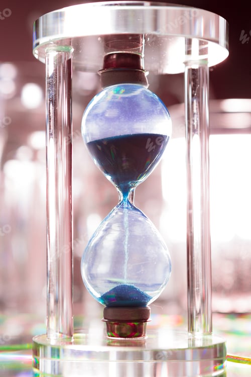 Preview: Blue hourglass on gray background close up