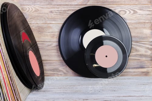 Preview: Vinyl record in front of a collection of albums, vintage process. Copy space for text.