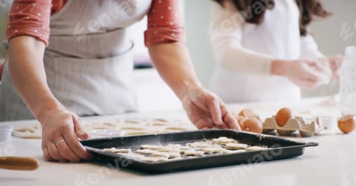 Preview: Hands, baking and mother with kid in kitchen with dough for learning with cookies or biscuits. Tray
