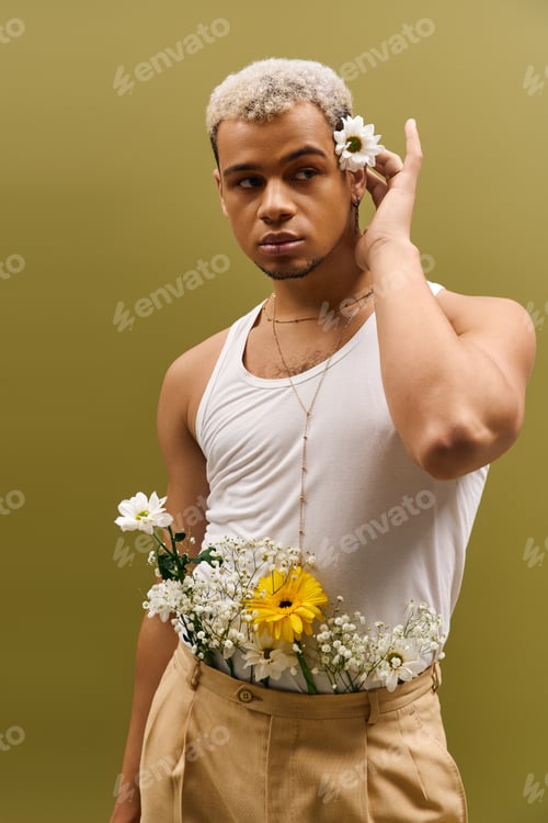 Preview: Young man showcases vibrant style in floral-inspired studio shot