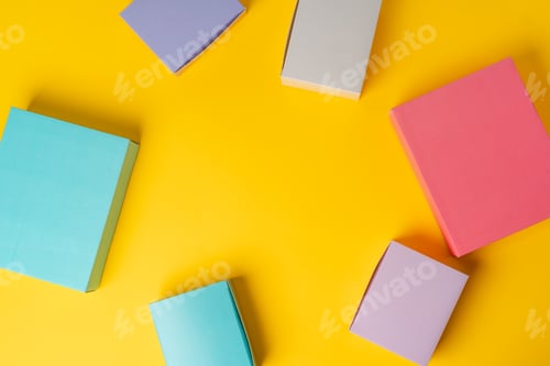 Preview: Colorful cardboard boxes on yellow background, copy space