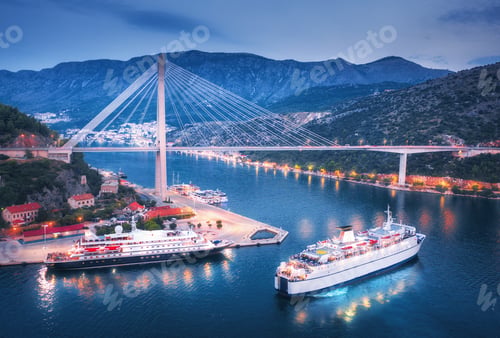 Preview: Aerial view of cruise ship at harbor and bridge at night