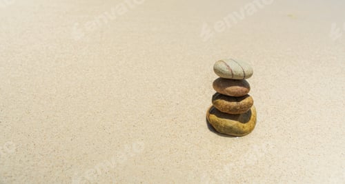 Preview: Stones balanced on beach. Zen stones meditation and relaxation. Japanese zen garden