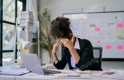 Preview: Stressed african american businesswoman suffering from headache in office