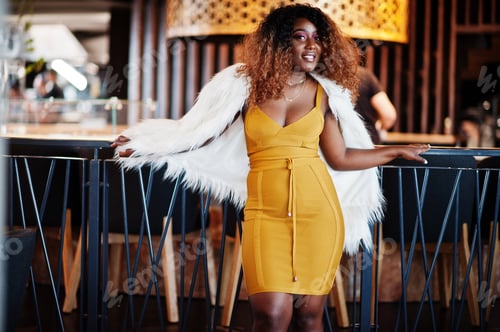 Preview: African american woman in yellow dress