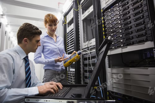 Preview: Team Of Technicians Using Digital Cable Analyser On Servers In Large Data Center
