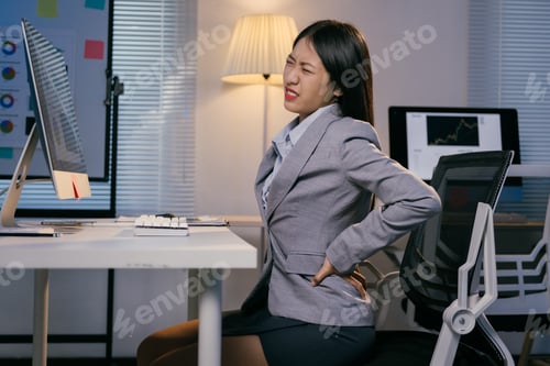 Preview: Young manager having backache after long time working on computer, incorrect posture problems, suffe