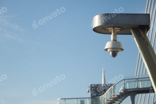 Preview: Security camera overlooking a modern urban bridge during daylight
