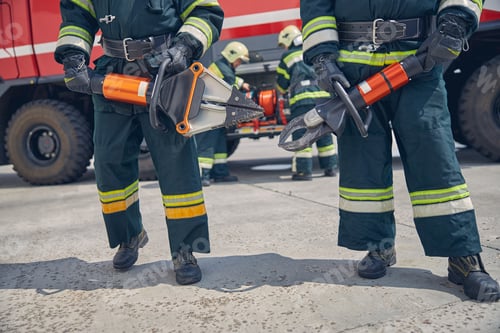 Preview: Men wearing protective uniform standing in front of fire modern machine