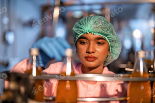 Preview: Beverage worker in drink factory stand working near drinking bottle conveyor production line