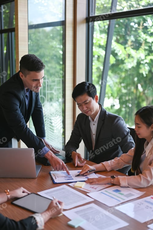 Preview: Businessman explaining business plans to his colleagues during meeting.