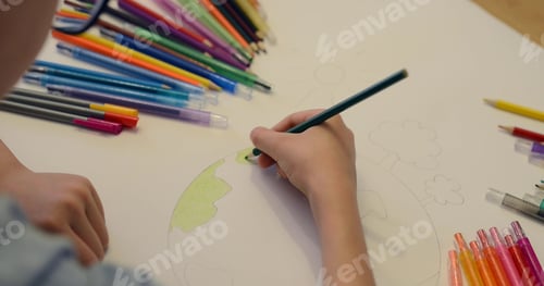 Preview: Child boy draws planet for earth day. Protection of enviroment, Mother Earth Day. Save our planet