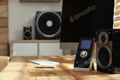 Preview: Modern computer with audio speaker system in bright room