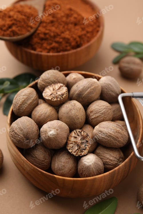 Preview: Nutmeg powder and seeds on light brown background