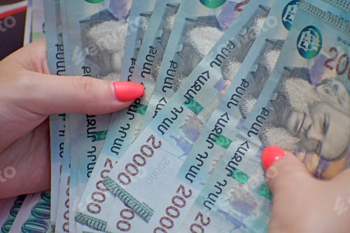 Preview: Closeup of female hands holding and counting many Armenian 20000 dram bills