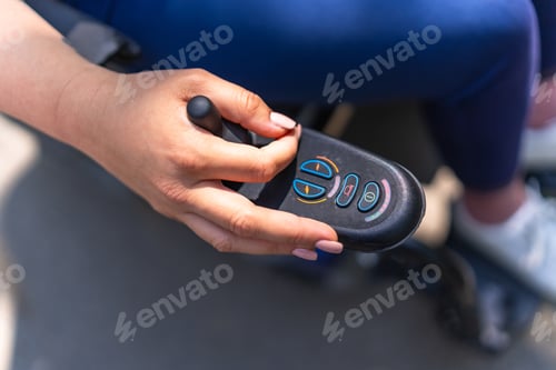 Preview: Woman using joystick controller on electric wheelchair, navigating with ease and independence