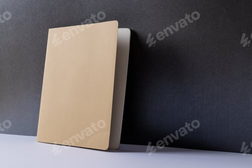 Preview: Close up of beige notebook with copy space on black background