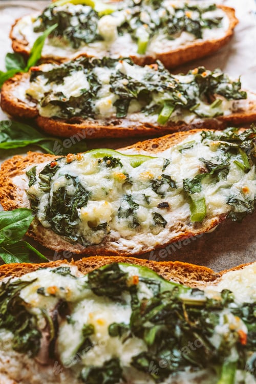 Preview: Toasted Bread Slices Topped with Greens and Cheese