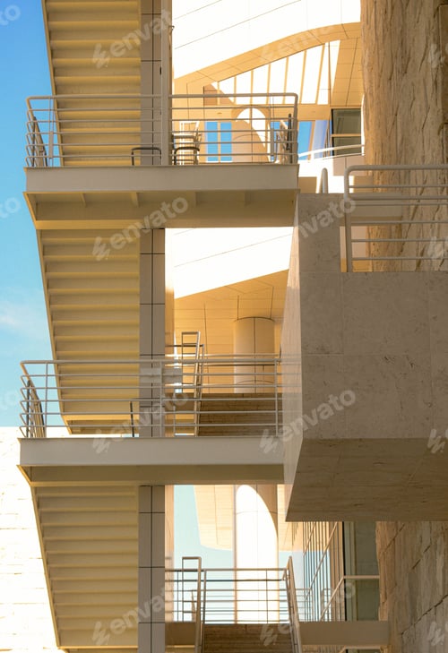 Preview: Vertical shot of a stone building with stairs isolated on background of cloudy blue sky