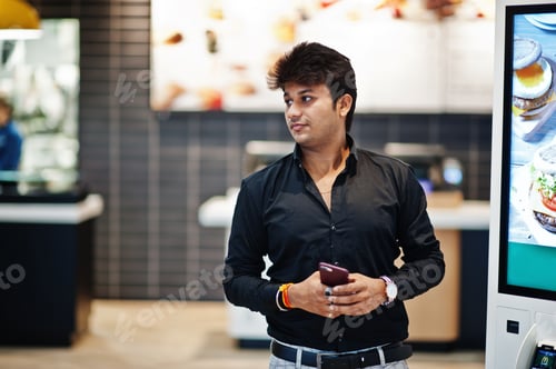 Preview: Indian man at fast food cafe