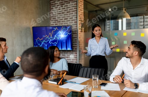 Preview: Multiethnic Group Of Business People Communicating During Corporate Meeting In Office