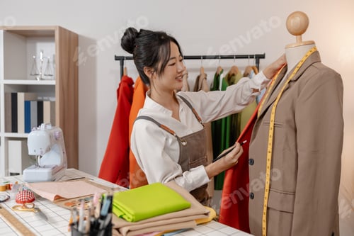 Preview: Fashion designer selecting fabric and measuring material