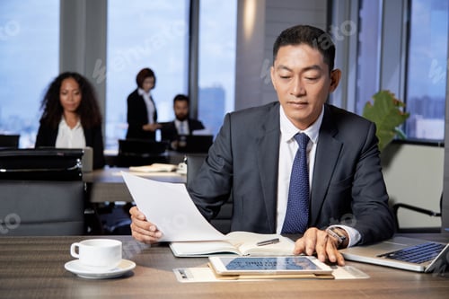 Preview: Ethnic businessman working with papers