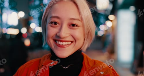Preview: Japanese, city and portrait of happy woman at night in Tokyo with freedom on travel, adventure or j