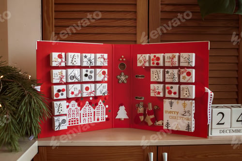 Preview: Pretty girl holds original advent calendar made of jewelry boxes and binder, Christmas diy craft