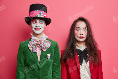 Preview: Cheerful hatter poses near woman zombie dress and wear makeup for halloween stand next to each other