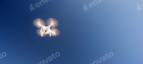 Preview: White Quadcopter Drone Flying Hoovering Blue Sky
