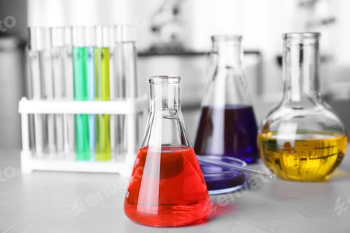 Preview: Laboratory glassware with samples on table indoors, space for text. Solution chemistry
