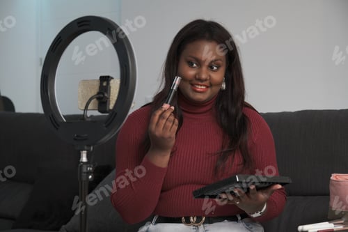 Preview: Young cuban woman streaming a beauty vlog from home.