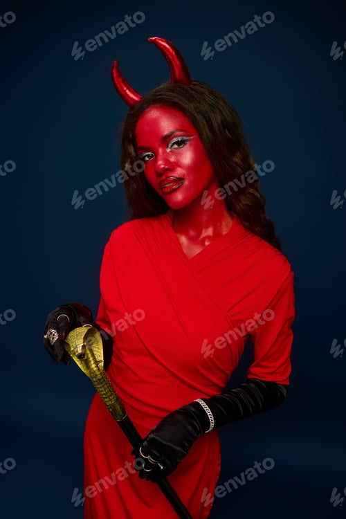 Preview: A stunning woman embraces the Halloween spirit in a bold red devil costume, complete with horns