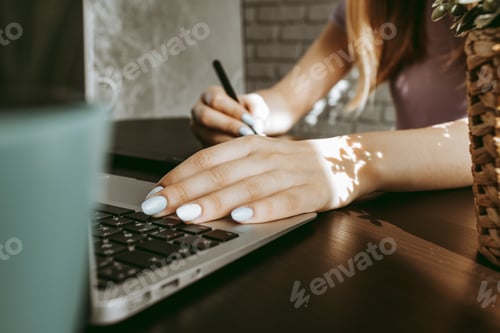 Preview: Close up of female graphic designer drawing sketches on graphic tablet