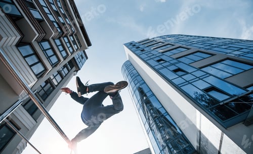 Preview: Young man doing parkour in the city at daytime. Conception of extreme sports