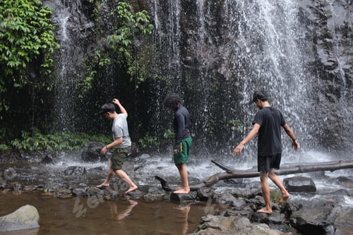 Preview: Barefoot Adventurers Exploring The Vibrant Jungle Waterfall With Refreshing Cool Water
