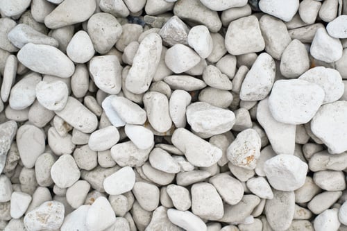 Preview: White smooth large stones, decorative element for garden and landscape. Textured stone background