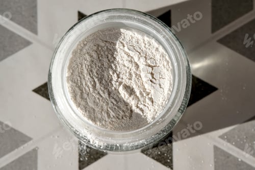 Preview: An open jar of face scrub-powder showing off its texture.