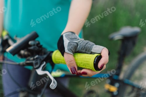 Preview: Close Up of a Womans Hand on a Mountain Bike Handlebars