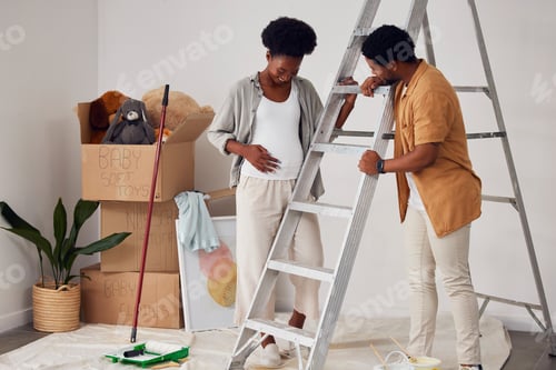 Preview: Ladder, pregnancy or black couple in home renovation, diy or house remodel together in apartment. L