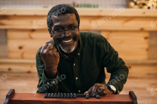 Preview: happy african american man celebrating victory in kicker