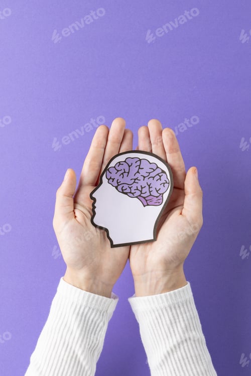 Preview: Hands holding head silhouette with brain on purple background with copy space